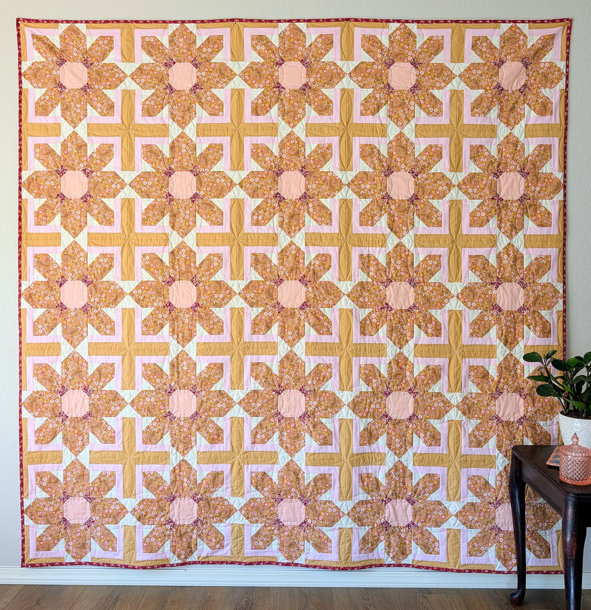 A large scale floral quilt with repeating pattern in the timless Charming One fabric collection by Sharon Holland for Art Gallery Fabrics