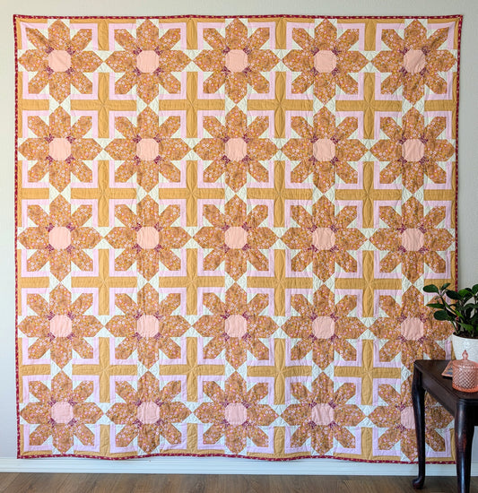 A large scale floral quilt with repeating pattern in the timless Charming One fabric collection by Sharon Holland for Art Gallery Fabrics